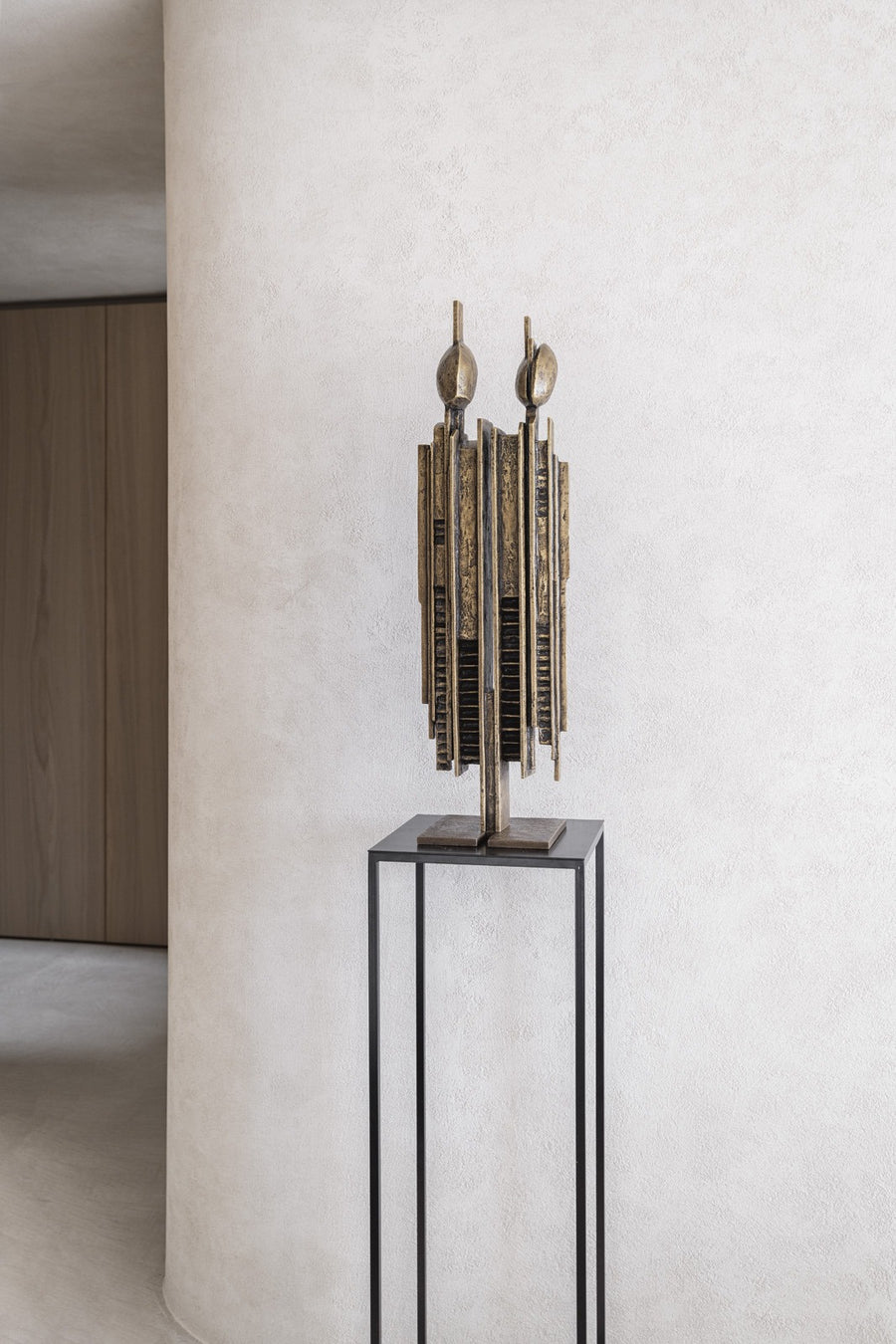 Abstract sculpture on a pedestal against a light wall called Luxta from Gardeco available at Spacio retail stores in Mumbai & Kolkata