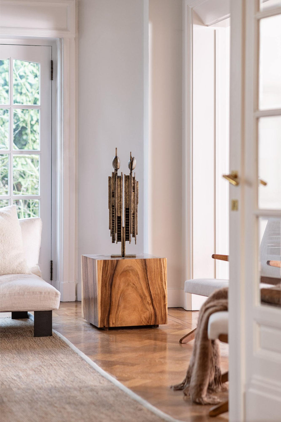 Wooden table with a decorative sculpture in a modern living room.