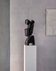 Artistic bronze sculpture by Gardeco Belgium on a tall white pedestal, designed for statement decor and exclusive styling in Indian homes.