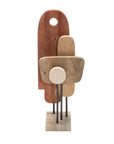 Abstract sculpture with geometric shapes in travertine marble on a white background from Giobagnara at Spacio Mumbai store. 