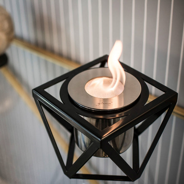 Modern black table top bioethano fireplace with against a neutral background