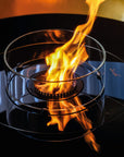 Glass container with flames inside on a reflective surface