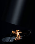 Small flame in a dark setting