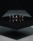 Modern black fire pit with flames on a dark background
