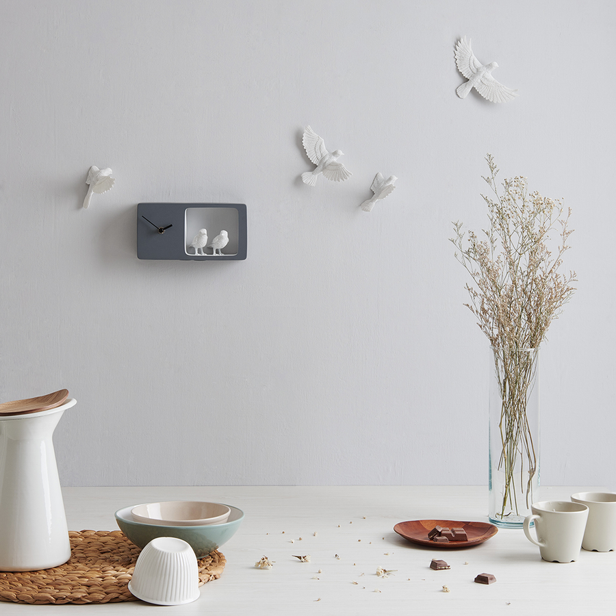 Haoshi Sparrow Clock in Dark Gray color on a grey wall with table ware accessories beside a vase available at Spacio india for modern and luxury interiors from our Timepieces and clocks collection.