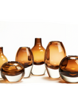 Henry Dean amber-toned glass vases in various sizes, handblown in Belgium and available at Spacio India for upscale interior styling.