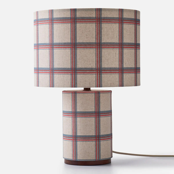 A checkered pattern fabric table lamp on a white background