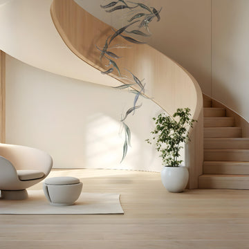 Modern interior with a spiral staircase, white chair, and potted plant and a fluid art light installation by Iris Cristal, available at Spacio retail stores in Mumbai & Kolkata.