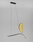 Modern pendant light with a yellow glass shade on a gray background