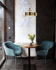 Elegant Italamp Crono Suspension Lamp with layered gold rings and glass pendants, styled in a contemporary café setting, available at Spacio India.