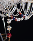 Close-up of Italamp Dogma chandelier arm detail with red, blue, and clear crystal pendants, highlighting luxury lighting by Italamp at Spacio India.