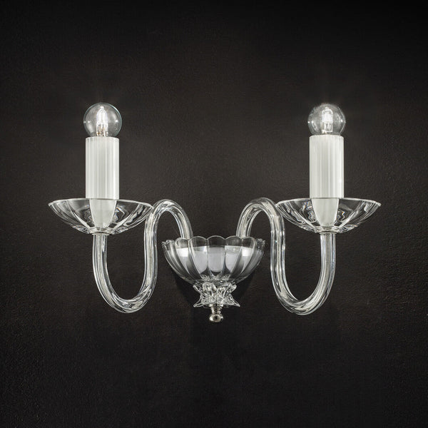 Italamp Evoque Wall Lamp in hand-carved clear crystal with twin arms and candle-style bulbs, available at Spacio India for luxury wall lighting.