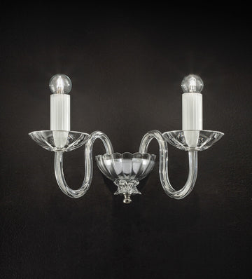 Italamp Evoque Wall Lamp in hand-carved clear crystal with twin arms and candle-style bulbs, available at Spacio India for luxury wall lighting.