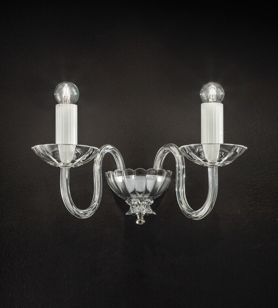 Italamp Evoque Wall Lamp in hand-carved clear crystal with twin arms and candle-style bulbs, available at Spacio India for luxury wall lighting.