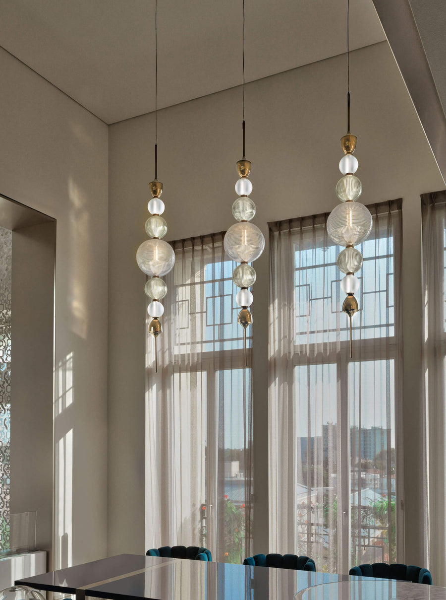 Cluster of Italamp Greta Suspension Lamps in a modern dining space with tall windows, bringing Italian luxury lighting to interiors – Spacio India.