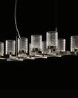 Modern chandelier with crystal-like glass shades on a black background from Italamp available at Spacio in India. 