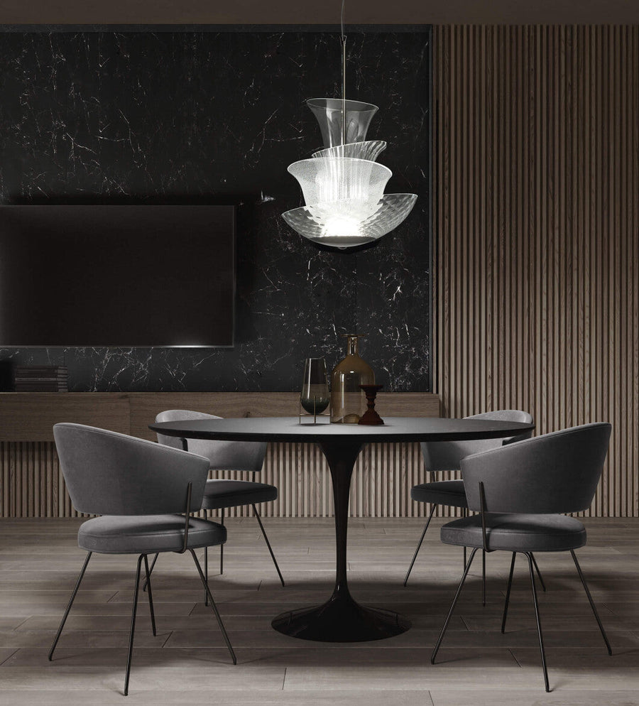 Modern dining room with Italamp Trevi Suspension Lamp from Italy, featured at Spacio India. The sculptural glass design adds elegance above a round dining table.