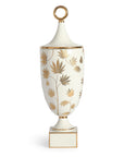 A Jonathan Adler JA Vase Botanist Ganja Urn with gold leaves on it.