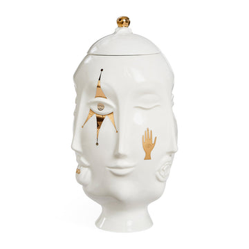 The Vase Glided Muse Frida Urn by Jonathan Adler is a charming white ceramic jar adorned with a face, perfect for adding a touch of artistic flair to your space. It is part of the Muse collection by Jonathan Adler.