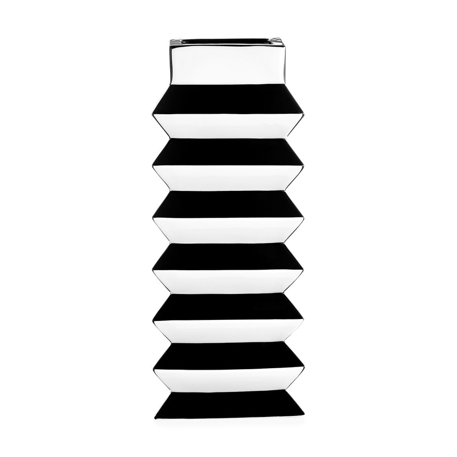 A stack of JA Vase Pleat Large Black White boxes on a white background, inspired by contemporary artistry and Wiener Werkstätte design.