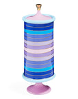 A blue, pink and purple striped Jonathan Adler JA Vase Scala Stripe Large Canister candy jar on a stand with 60s-inspired aesthetics.