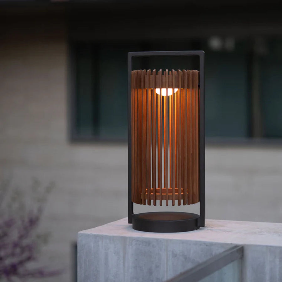 Solar Table lamp with wooden design on a concrete surface by Les Jardins available at Spacio retail stores in Mumbai & Kolkata.  