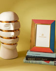 Jonathan Adler Atlas Sliced Gold Glided ceramic sculpture with books & decorative photo frame available at Spacio India for Luxury Homes collection of Sculpture & Art Objects.