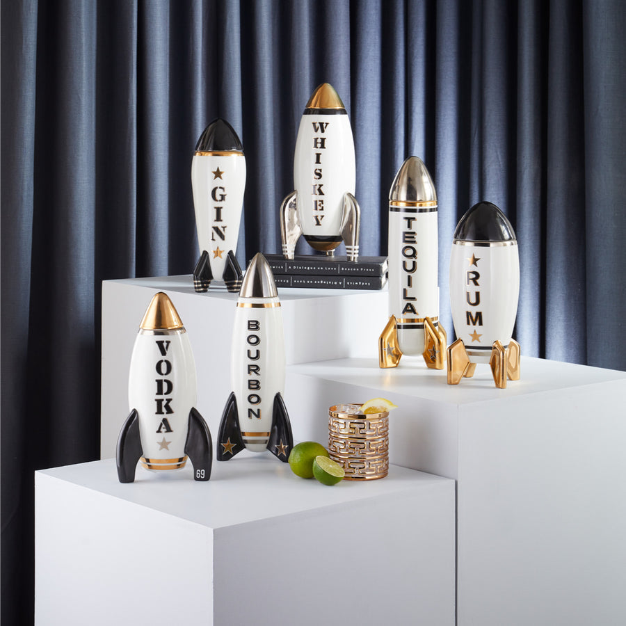 Jonathan Adler Rocket Gin decanter with other decanters on a pedestals available at Spacio India for Luxury Homes collection of Bar Accessories