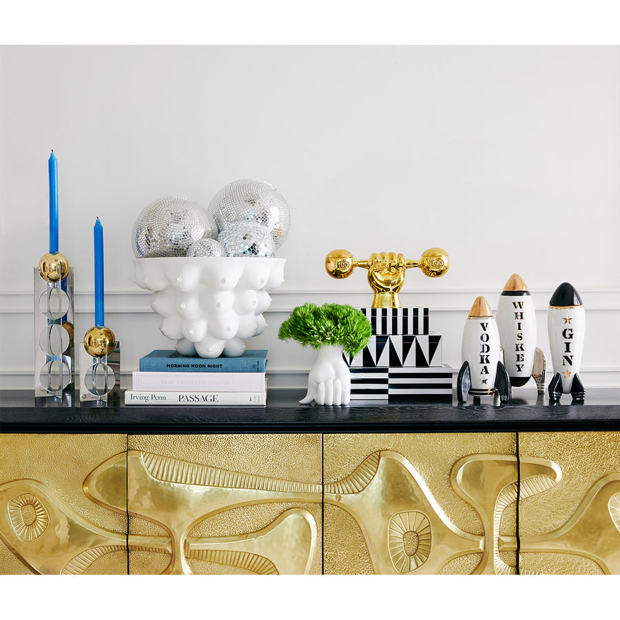 Jonathan Adler Rocket Gin decanter with other home decor accessories arranged on a console table available at Spacio India for Luxury Homes collection of Bar Accessories