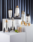 Jonathan Adler Rocket Rum Decanter on a pedestal with other decanters available at Spacio India for luxury home decor collection of Bar Accessories.