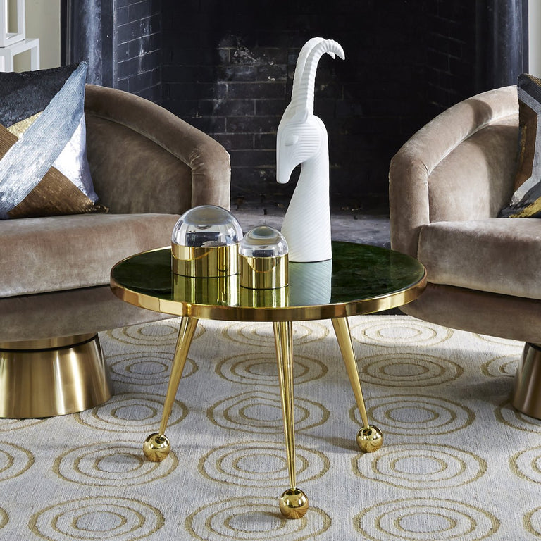 Jonathan Adler Menagerie Gazelle white Sculpture on a gold coffee table in an interior available at Spacio India for Luxury Home Decor collection of Sculpture & Art Objects.