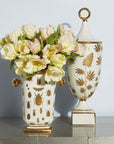 Jonathan Adler Botanist Ganja Urn vessel on a surface with decorative flowers in it beside Botanist Specimen vase available at Spacio India for Luxury Home Decor Accessories collection.