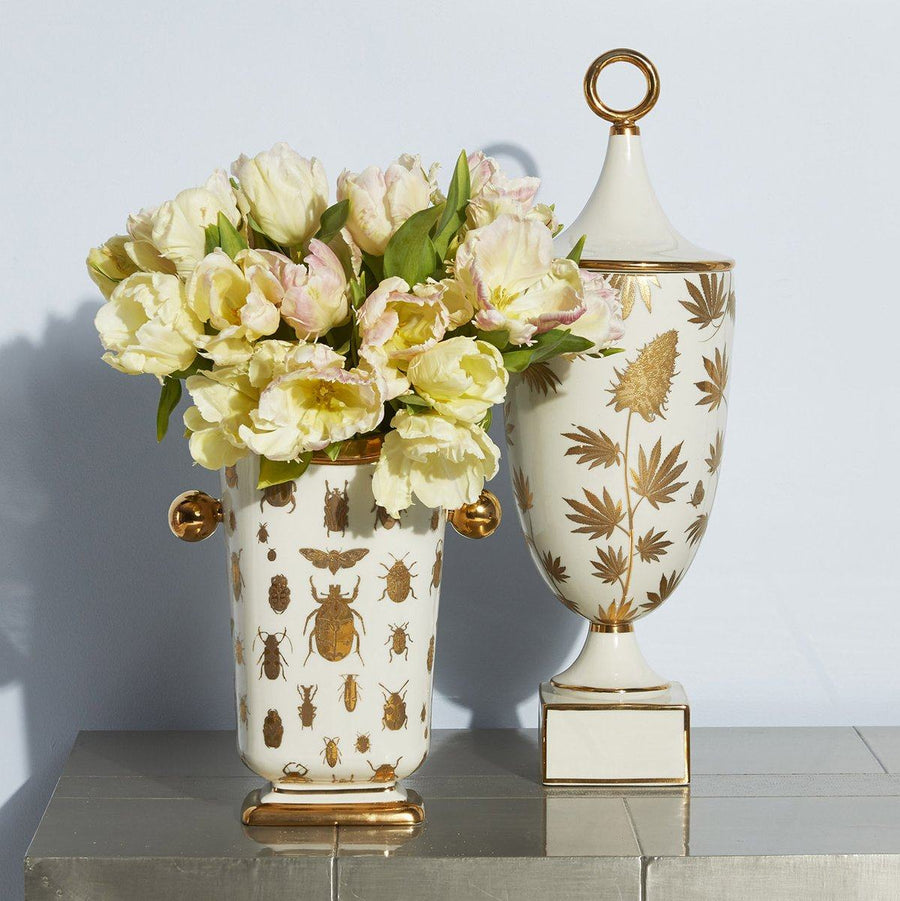 Jonathan Adler Botanist Ganja Urn vessel on a surface with decorative flowers in it beside Botanist Specimen vase available at Spacio India for Luxury Home Decor Accessories collection.