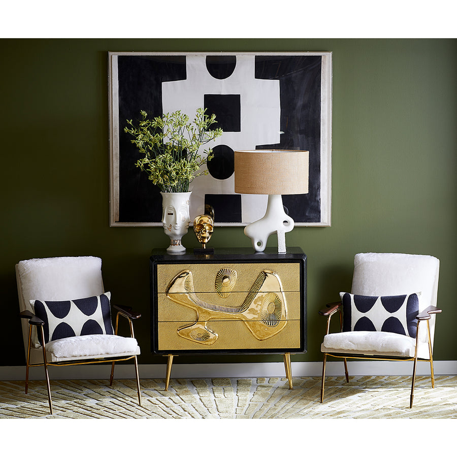 Jonathan Adler Muse Dora Maar Urn glided vase on a gold console table with a gold finish sculpture & ceramic table lamp in a seating space of interior available at Spacio stores India for Luxury Home Decor Accessories collection.