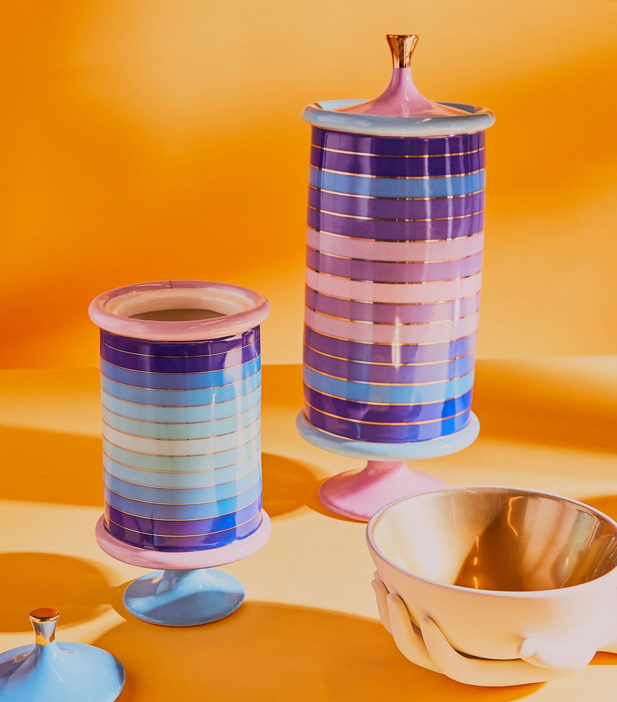 Jonathan Adler Scala stripe Vanister Tall Vase on a orange surface with bowl available at Spacio India for Luxury Home Decor Accessories collection.