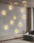 Modern living room with a geometric light fixture on a concrete wall.