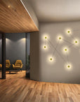 Modern interior with a wall-mounted light fixture casting a star-like pattern.