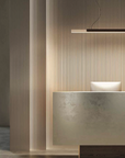 A harmonious synthesis of form and function, featuring a modern reception desk illuminated by the KDLN Dala Linear Home Office Desk Ceiling Light in a modern office.
