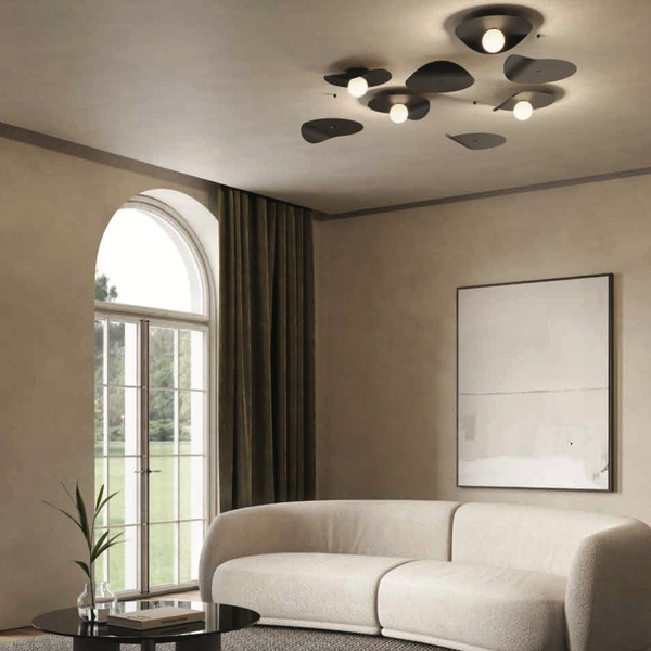 A living room with a white couch, large windows, and a KDLN blown glass lamp.