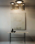 A retro-style table with a KDLN Giass Ceiling Light and a painting on the wall.