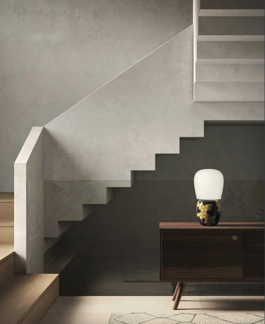 A KDLN Hive table lamp illuminates the staircase in a living room.