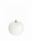 White glass table lamp with a copper stem on a white background