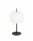 Table lamp with white shade and black base on a white background
