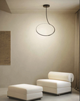 A room with two chairs and a KDLN Poise Ceiling Lamp by KDLN.