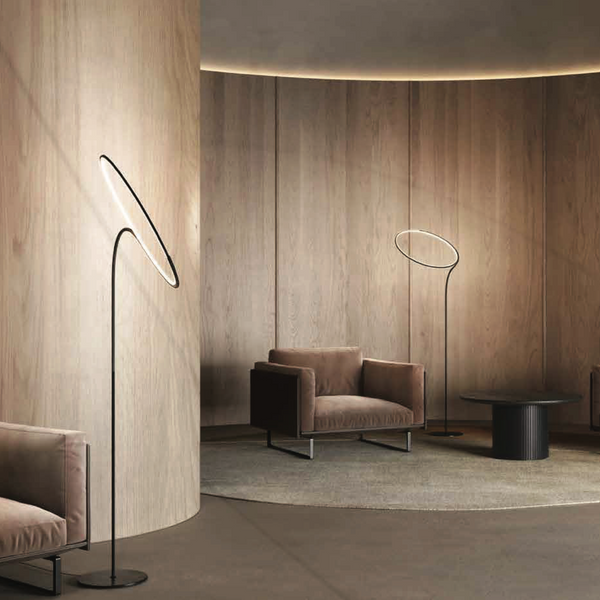 A modern living room with flexible wooden furniture configurations and a KDLN Poise Floor Lamp serving as a light source.