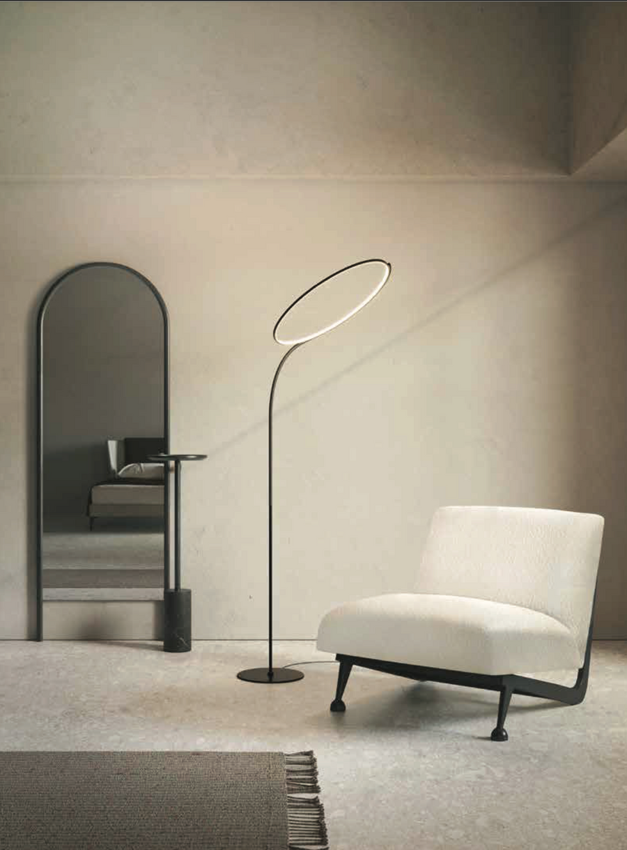 A flexible room configuration with a KDLN Poise Floor Lamp as the main light source.