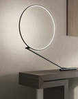 An adjustable KDLN Poise Table Lamp with a circle of light on top.