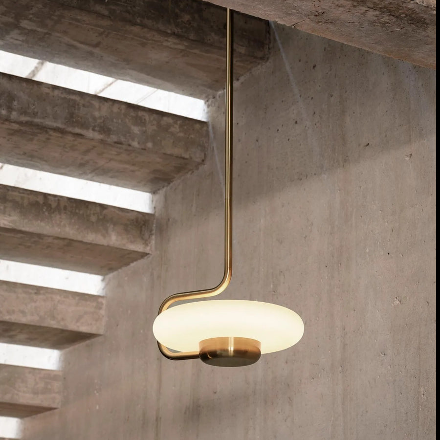 KDLN Tratto Suspension Light Spacio India in brass finish in a contemporary interior below  staircase