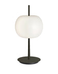 Table lamp with a white apple shaped glass and black base on a white background