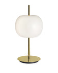 Table lamp with white shade and brass base on a white background